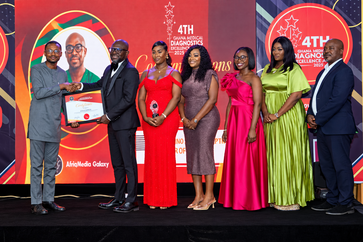 Elixir Clinic's team on stage at the 4th Ghana Medical and Diagnostics Excellence Awards in 2025, receiving the certificate for Most Promising Body Sculpting Center of the Year.